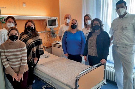 A group of Penn Medicine nurses and their German counterparts pose next to a bed in the cardiac unit at Städtisches Klinikum hospital 